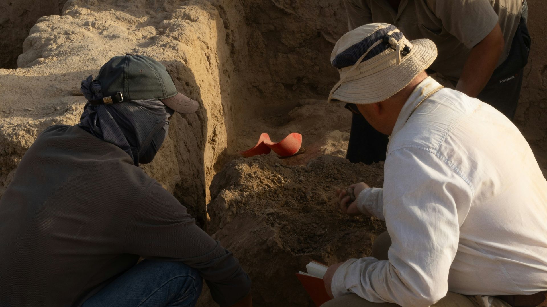 A group of men kneeling down next to each other