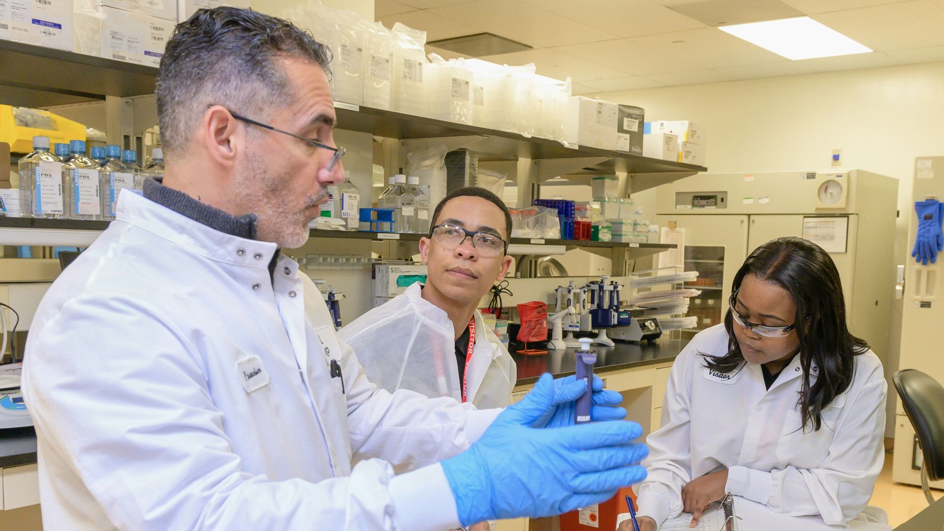 a group of people in a lab looking at something
