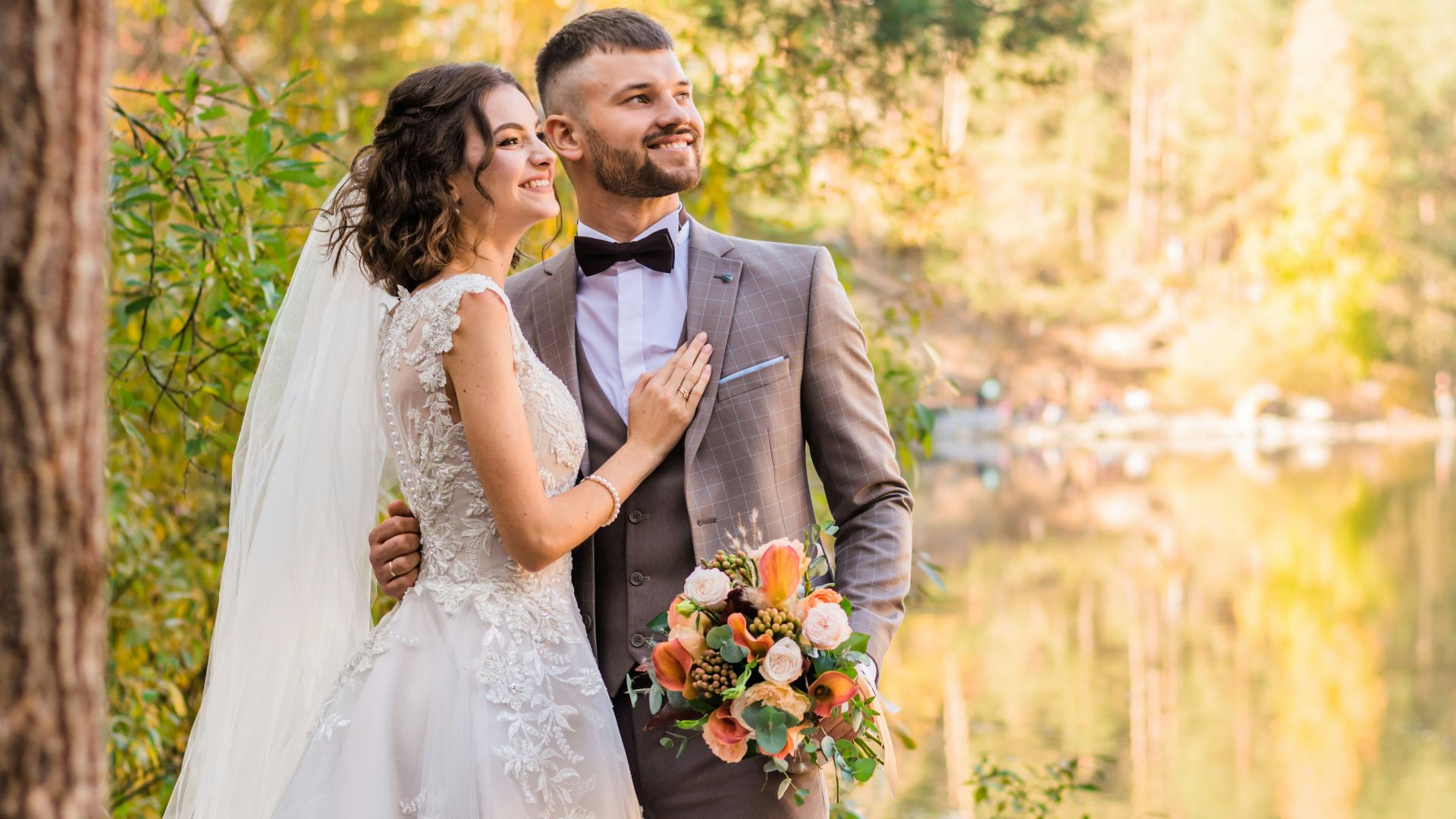 man in gray suit and woman in white wedding dress