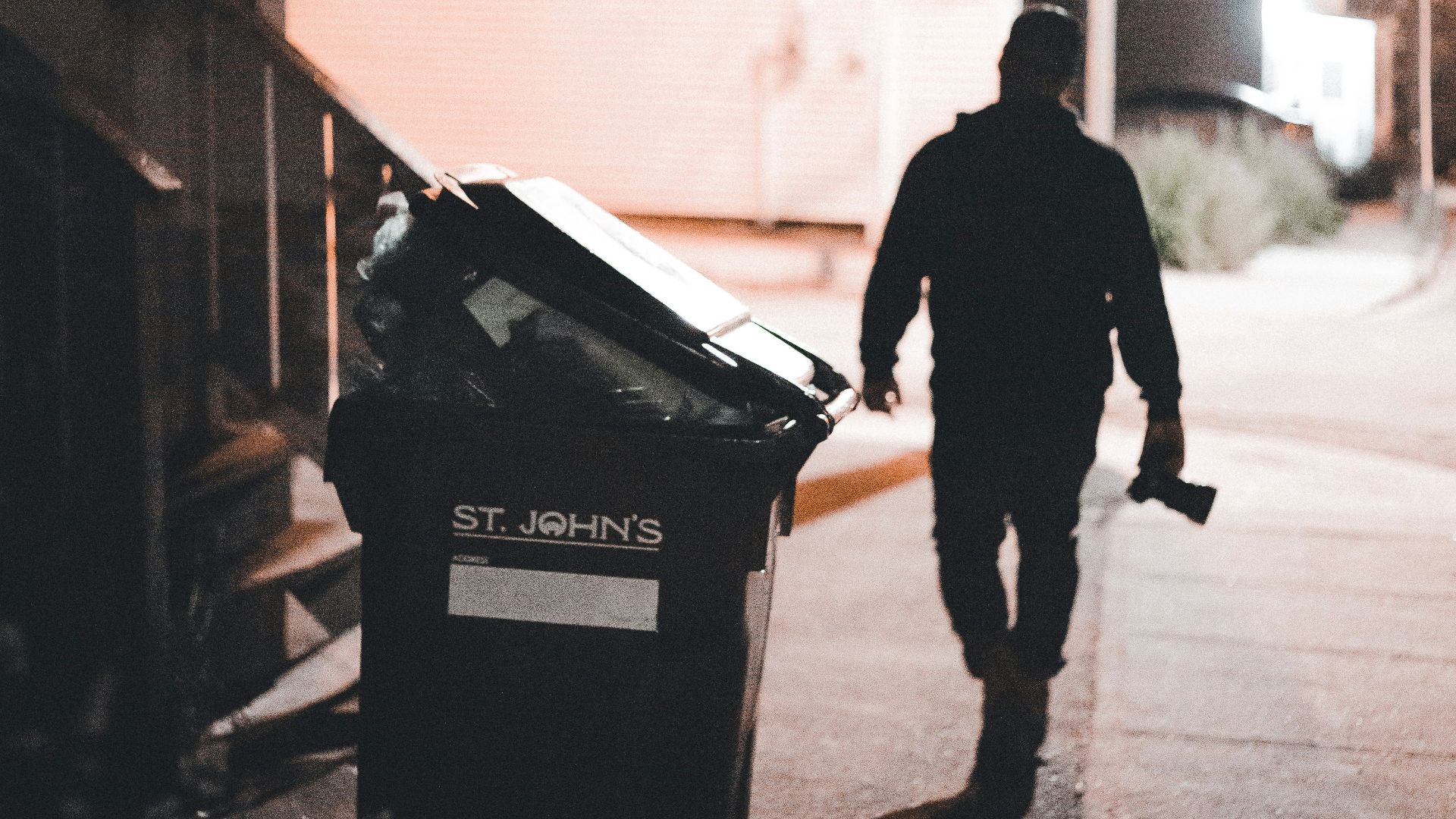a man walking down a sidewalk