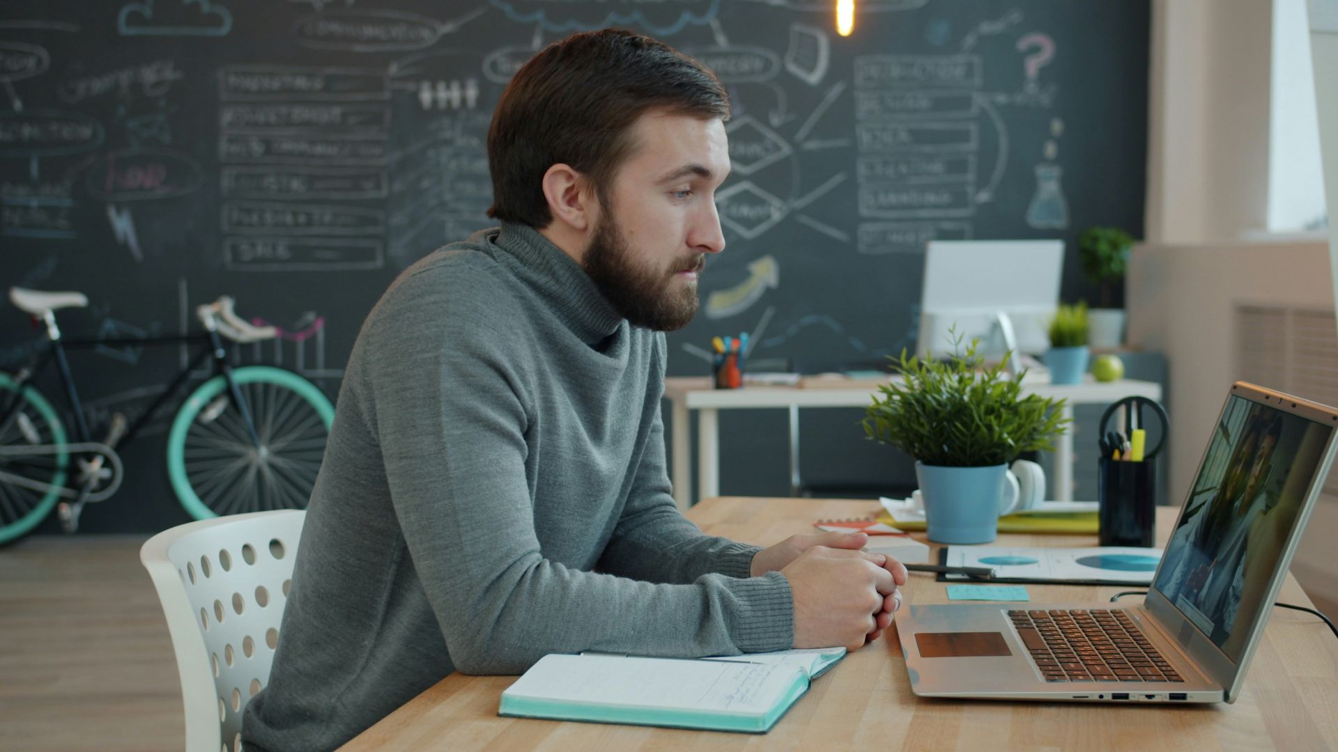 Man working on laptop in modern office space