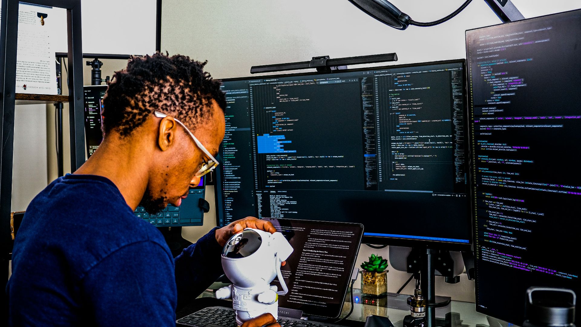 a man is looking through a microscope at a computer