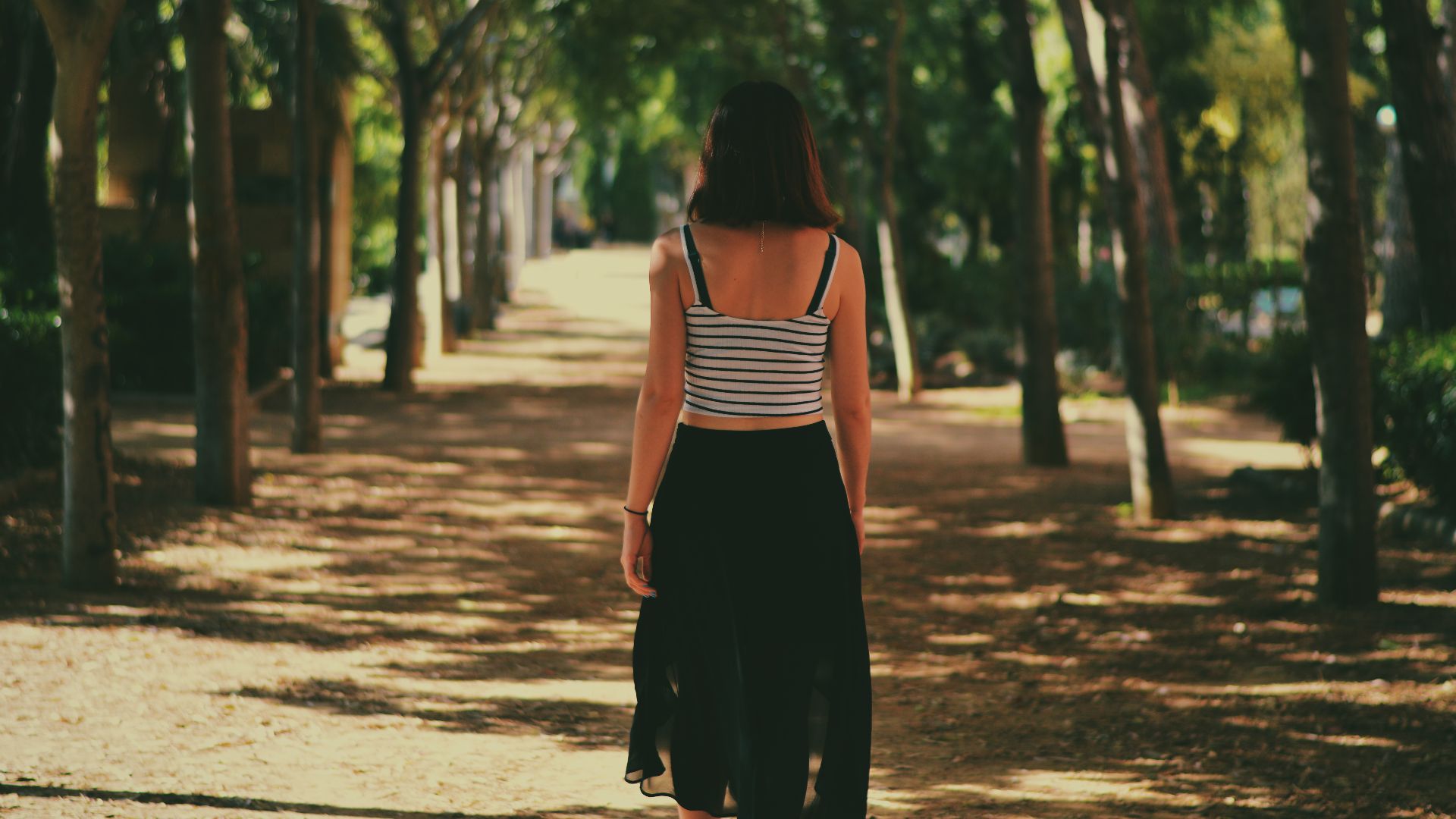 File:Woman walking down path (Unsplash).jpg