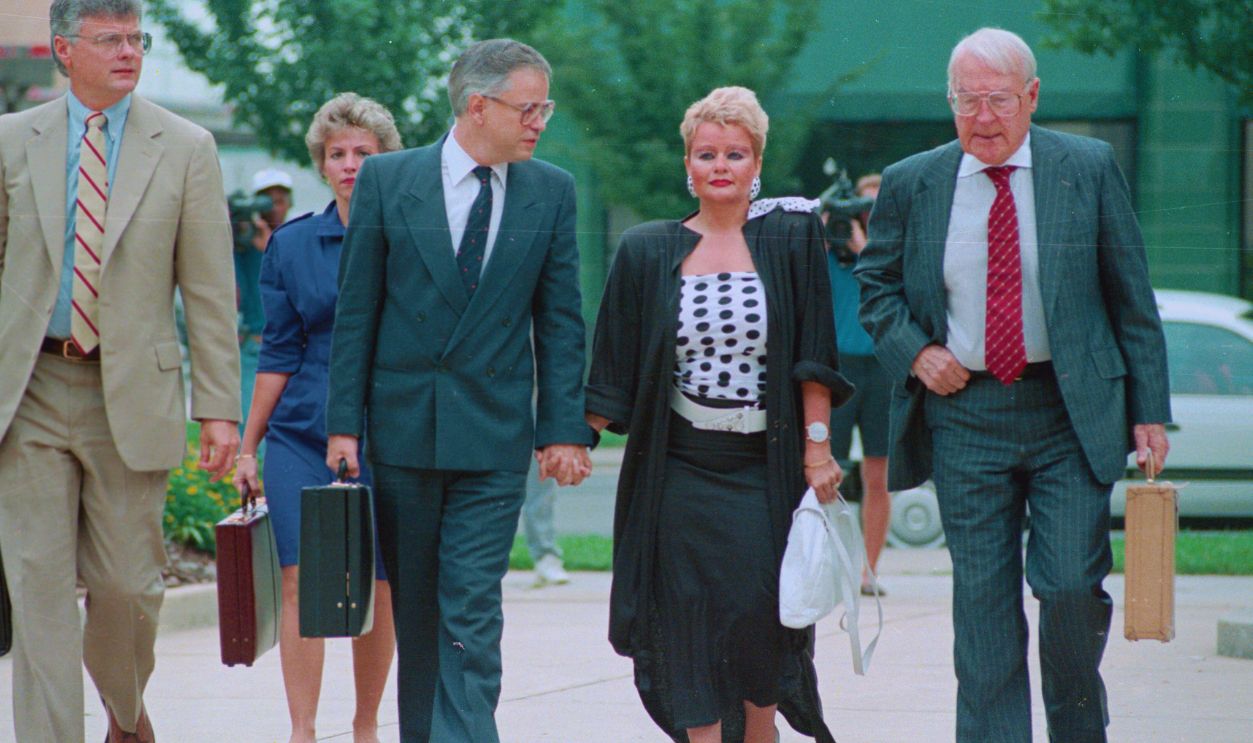 Gettyimages - 517791072, Jim Bakker and Wife Arriving at Courthouse (Original Caption) Charlotte, N.C.: PTL founder Jim Bakker holds the hand of his wife Tammy Faye as the two arrived at the Federal Courthouse in Charlotte. The PTL's founder fraud and conspiracy trial resumed.