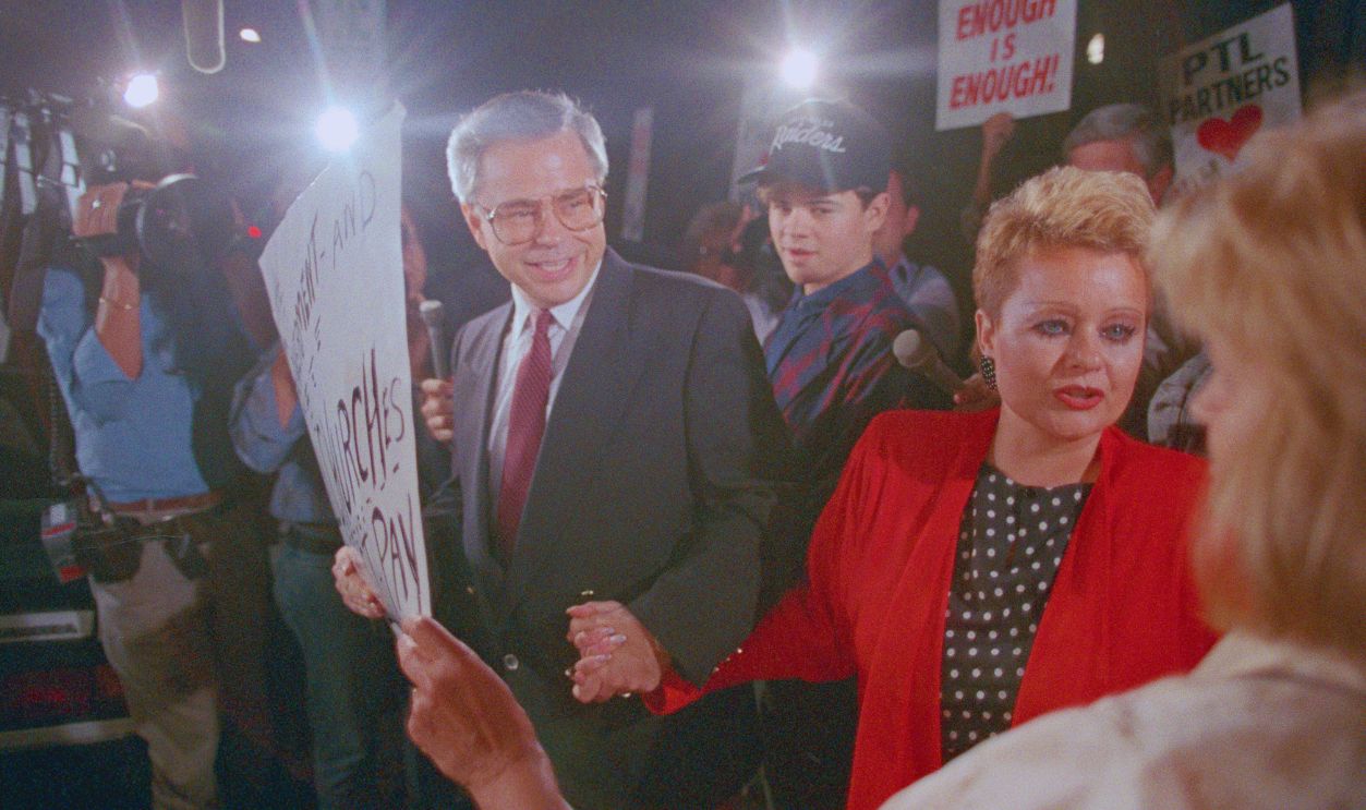 Gettyimages - 515328148, Jim Bakker and Wife Greeting Supporters (Original Caption) Charlotte, N.C.: PTL founder Jim Bakker, L, his son, Jamie, (C) and wife, Tammy Faye Bakker, greet supporters as they leave federal court in Charlotte. Bakker faces 120 years on 24 counts of fraud and conspiracy, as the case now is in the hands of the jury. 