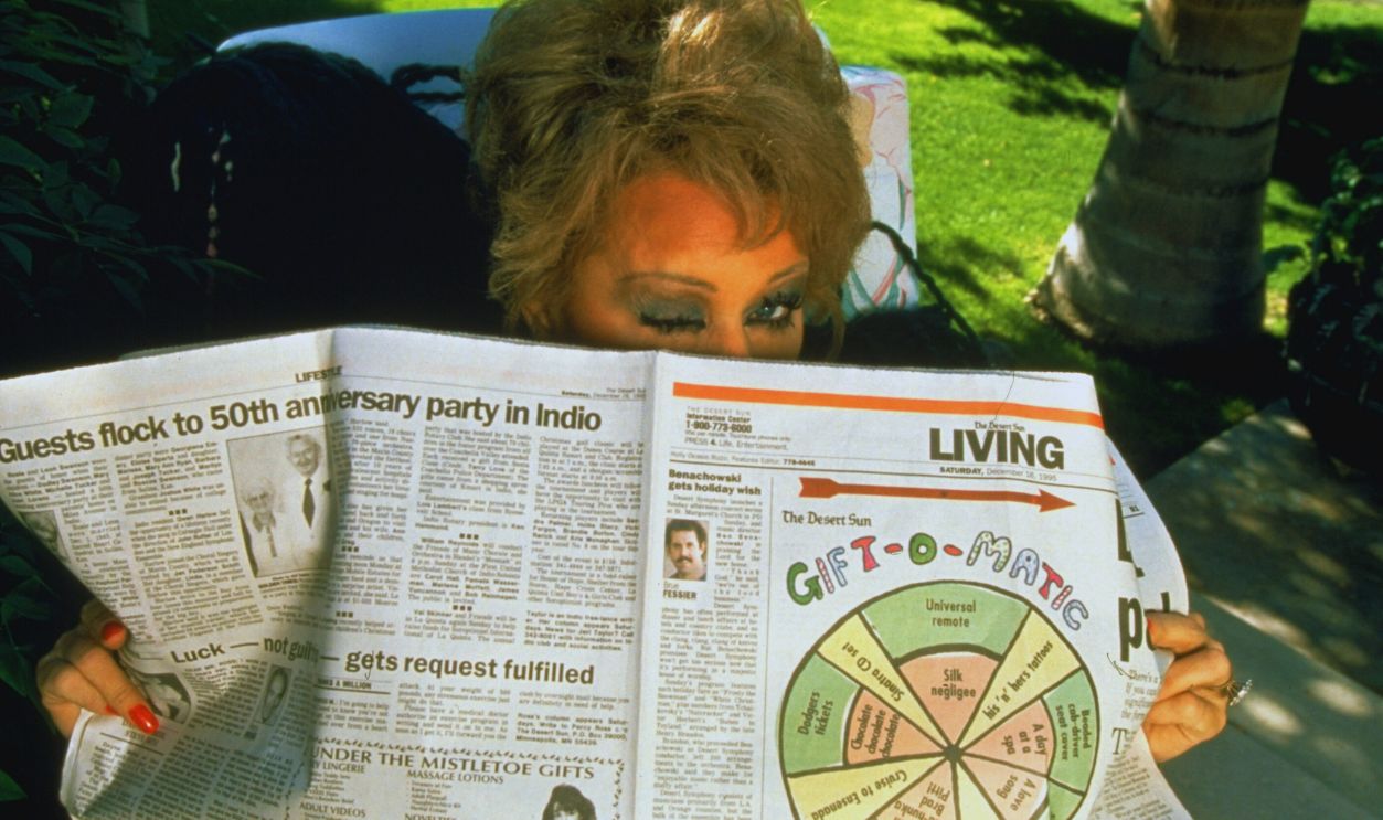 Gettyimages - 50478859, Tammy Faye Messner TV talk show host Tammy Faye Messner (formerly Baker) winking over top of newspaper outside nr. her home. 