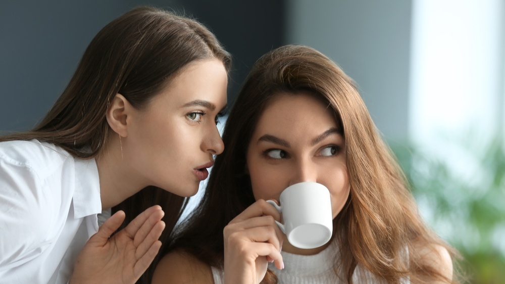 Female friends gossiping in a room