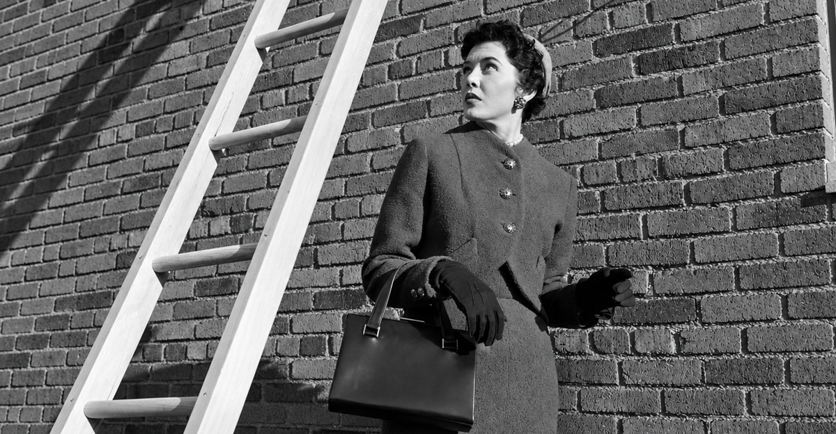 1950s provoking bad luck woman wearing suit and hat carrying handbag walking under ladder