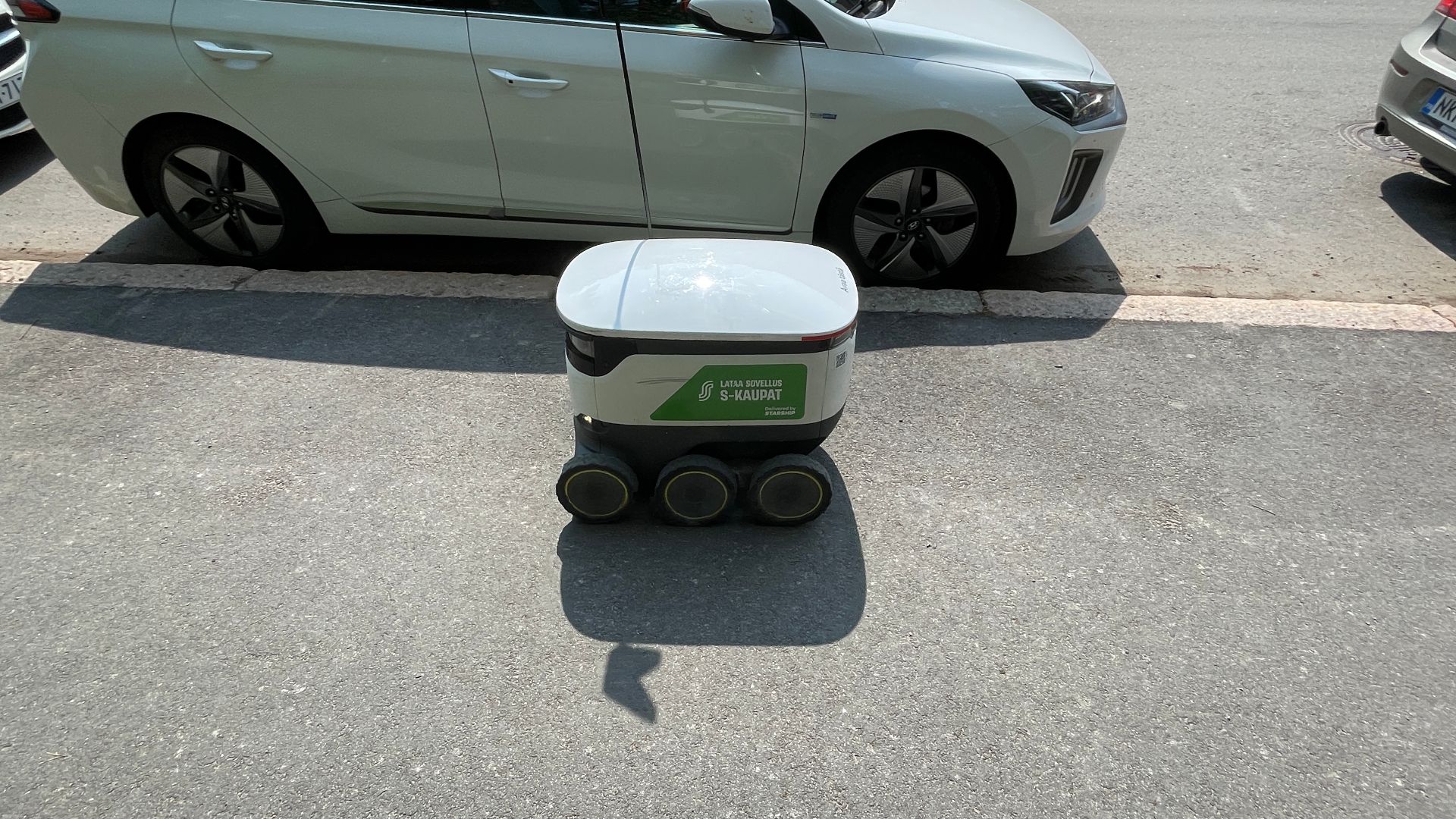 S-Market grocery delivery robot on a sidewalk of Paatsamatie in Pohjois-Haaga, Helsinki.