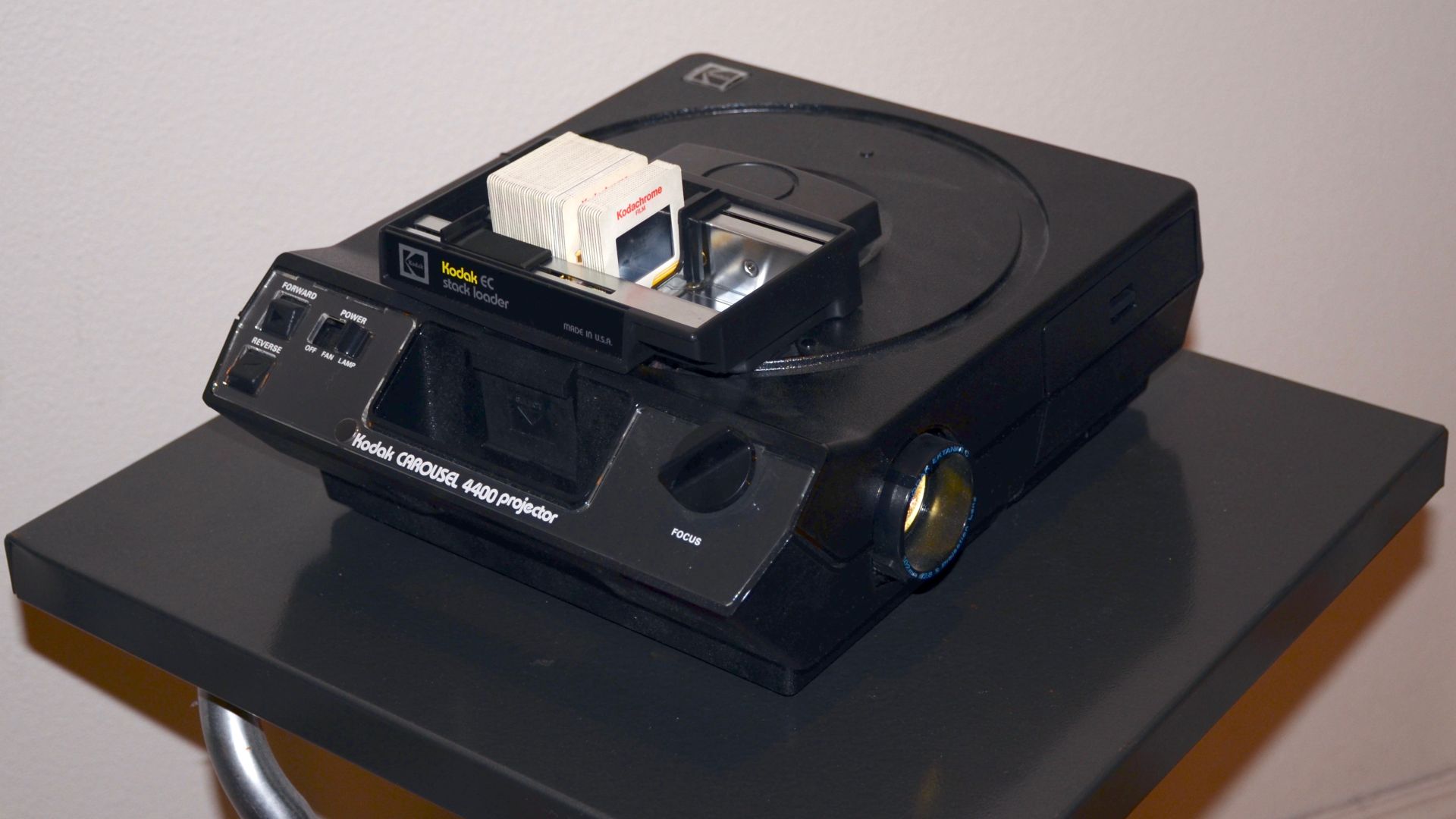 A Kodak Carousel 4400 slide projector with a stack loader in use.