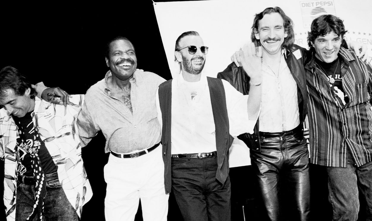 Portrait of, from left, musicians Nils Lofgren, Billy Preston (1946 - 2006), Ringo Starr, Joe Walsh, and Rick Danko (1943 - 1999) during a press conference at the Palladium to announce the inaugural tour of Ringo Starr and His All-Starr Band, New York, New York, June 20, 1989.