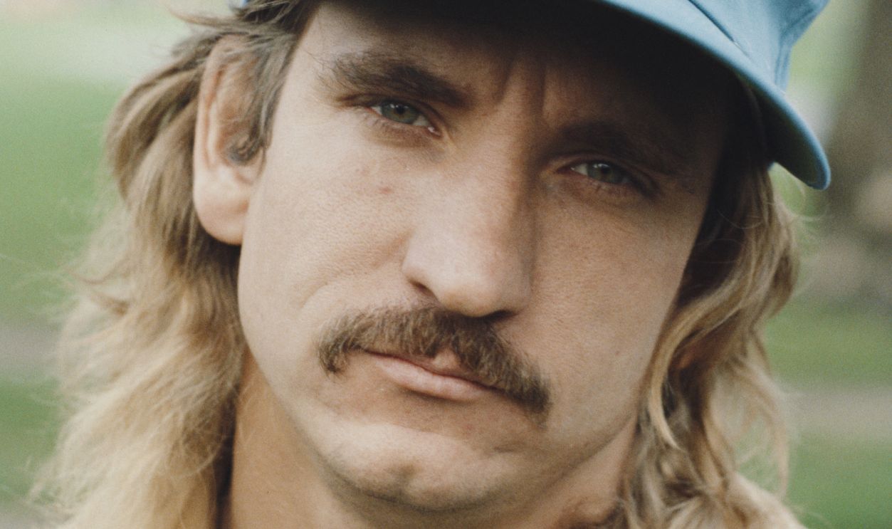 American singer-songwriter and guitarist Joe Walsh of rock band Eagles, posed wearing a baseball cap circa 1975. 