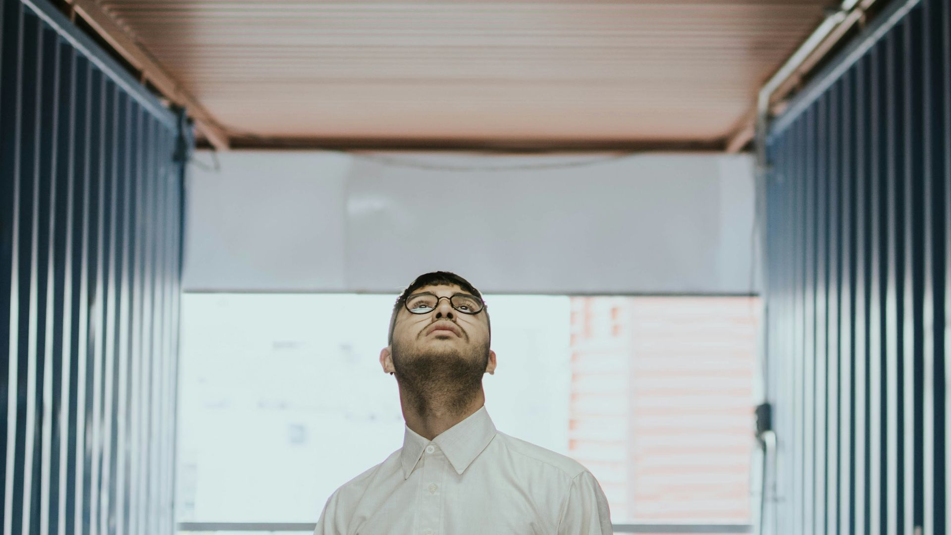 man staring above on brown ceiling