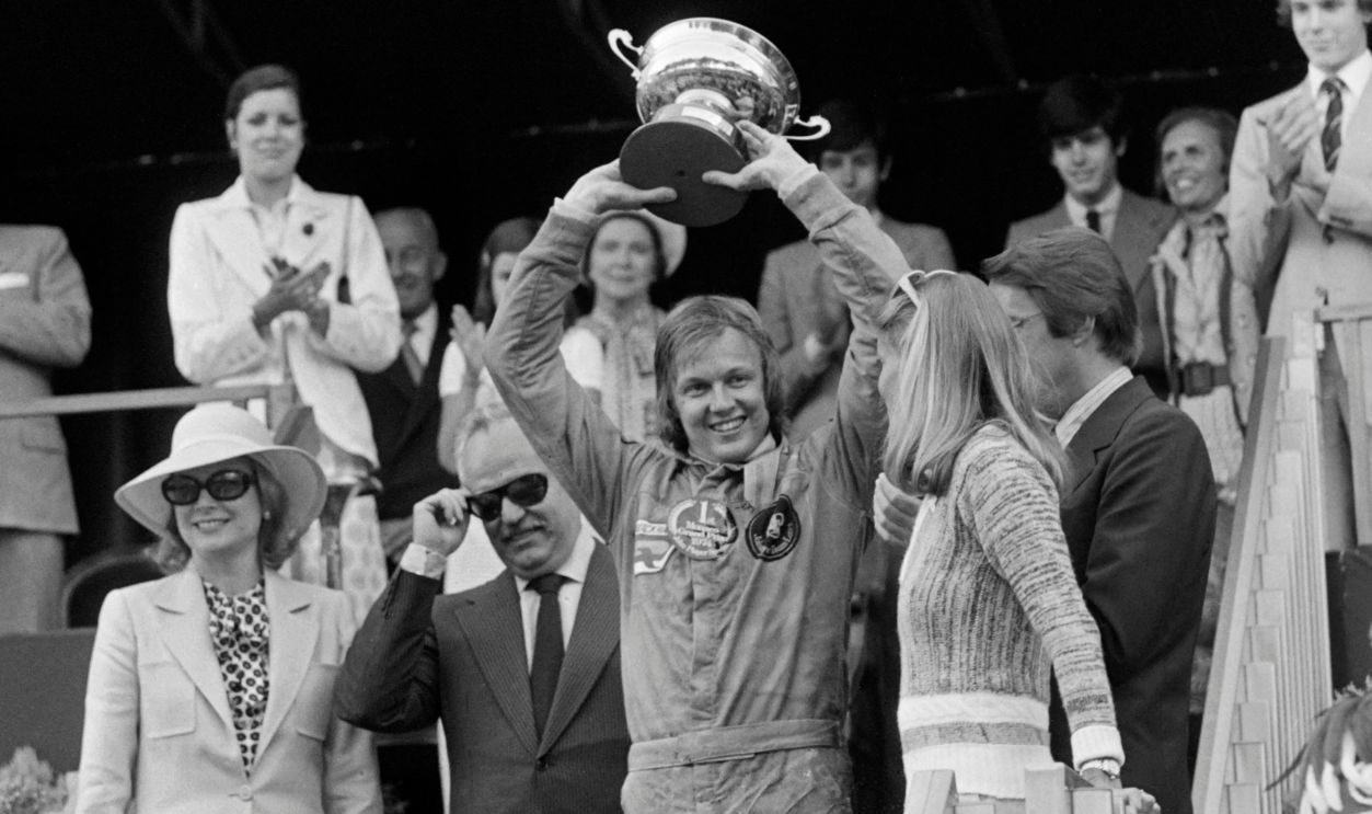 Swedish Formula One driver Ronnie Peterson (C), flanked by Monaco's Prince Rainier III (2nd L) and Princess Grace (L), holds the trophy on the podium celebrating his win at the 32th Monaco Formula One Grand Prix on May 26, 1974. In the background, Caroline and Albert II of Monaco and the two sons of French President Valéry Giscard d'Estaing.