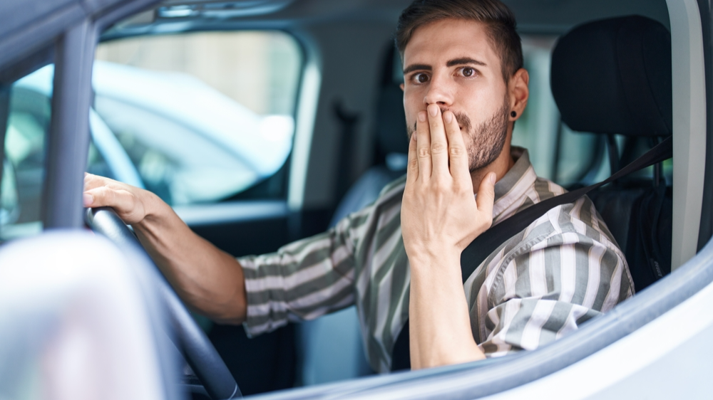 Shocked man in car looking at something