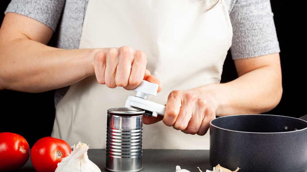 Woman using a can opener