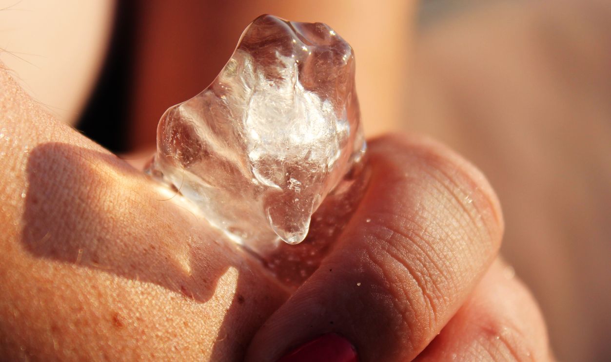 Shutterstock - 1457085215 - Ice applied to skin in hot sun.