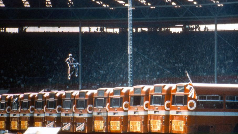American daredevil Evel Knievel makes a motorcycle jump over thirteen AEC Merlin buses at Wembley Stadium