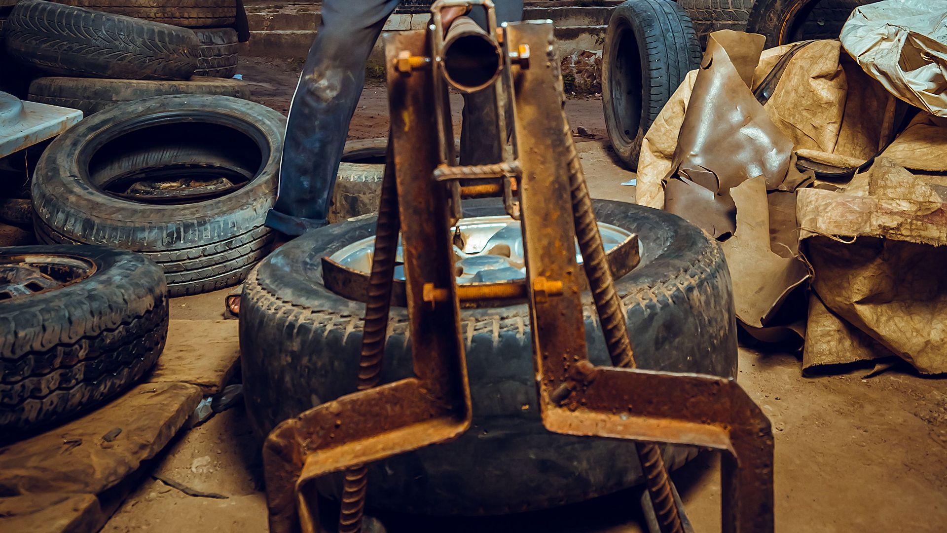 Cheerful African mechanic posing energetically in an outdoor auto repair shop in Accra, Ghana.