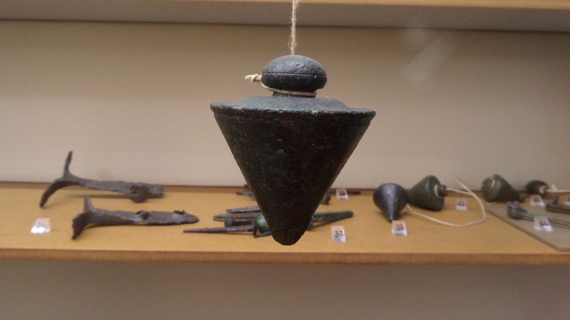 Roman plumb bob. In the Archaeological Museum, Split, Croatia. Bronze.