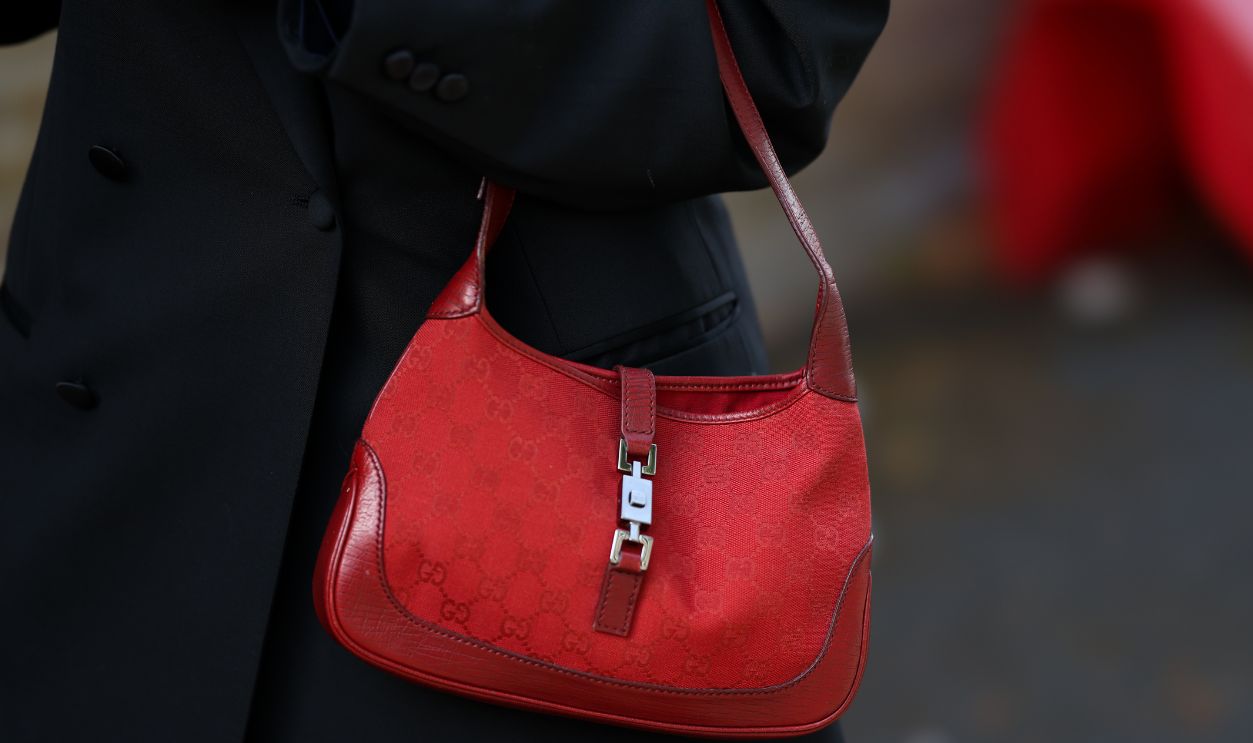 A guest is seen wearing a red GG monogram Jackie shoulder bag with red leather trim and silver tone hardware from Gucci outside the Edeline Lee presentation during Day Four of London Fashion Week on September 20, 2026 in London, England