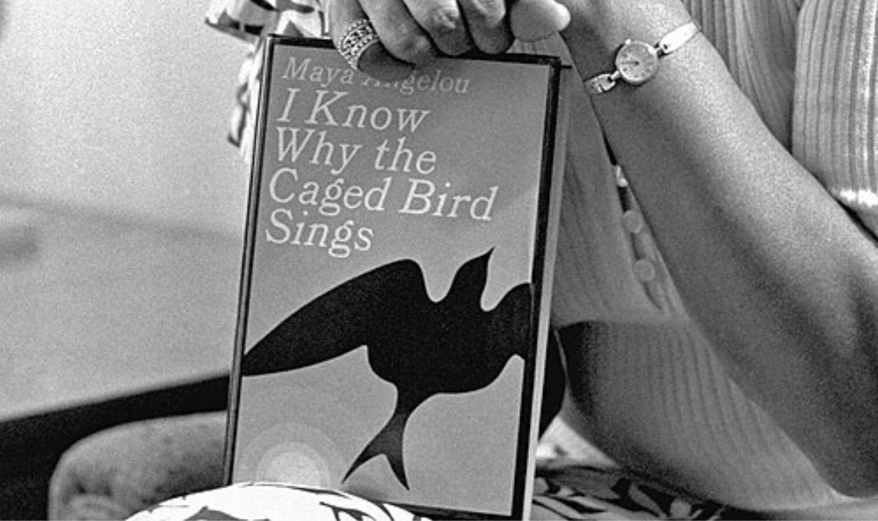 Portrait photograph of Maya Angelou with a copy of I Know Why the Caged Bird Sings in Los Angeles, November 3, 1971