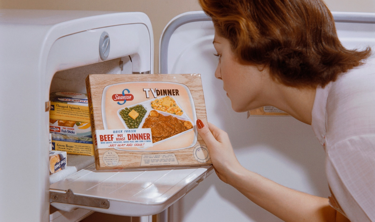 Woman Choosing TV Dinner from Freezer