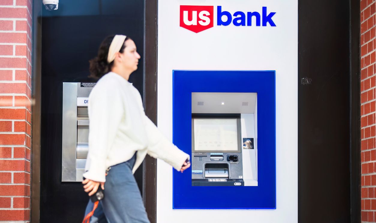 2024-11-15 Los Angeles USA  US Bank ATM with a pedestrian walking by in an urban setting.