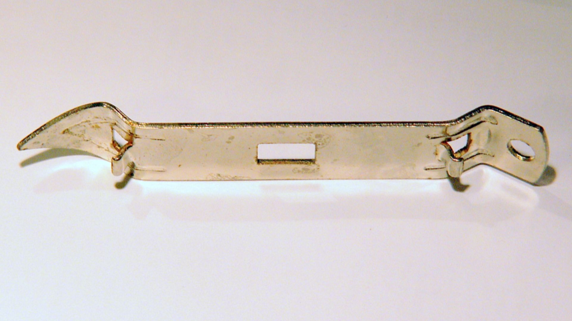 Combination bottle opener and can puncher (church key). Chrome-plated steel, 4.25 inch (108 mm) long.