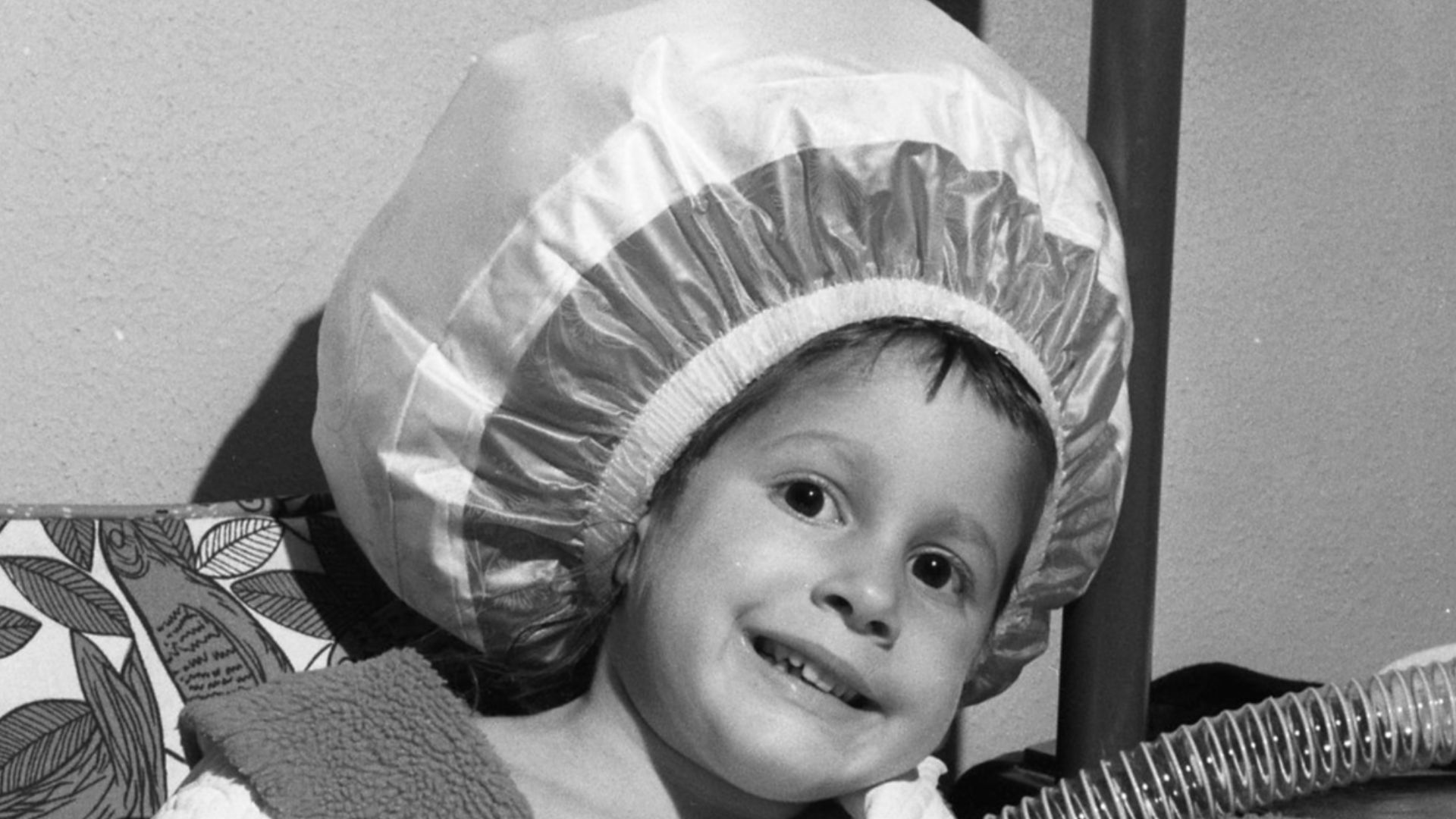 Girl using a bonnet-hood hair dryer, 1965