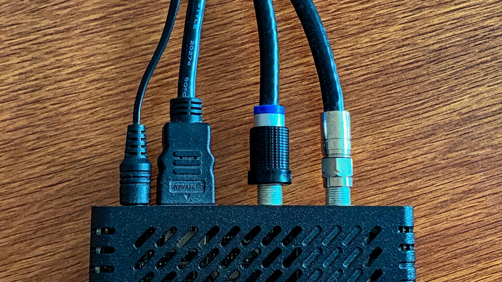 A Mediacom Pace DC60Xu high definition (HD) television (TV) (HDTV) digital transport adapter (DTA) digital adapter cable box. The device has a coaxial cable TV line in and HDMI video out.