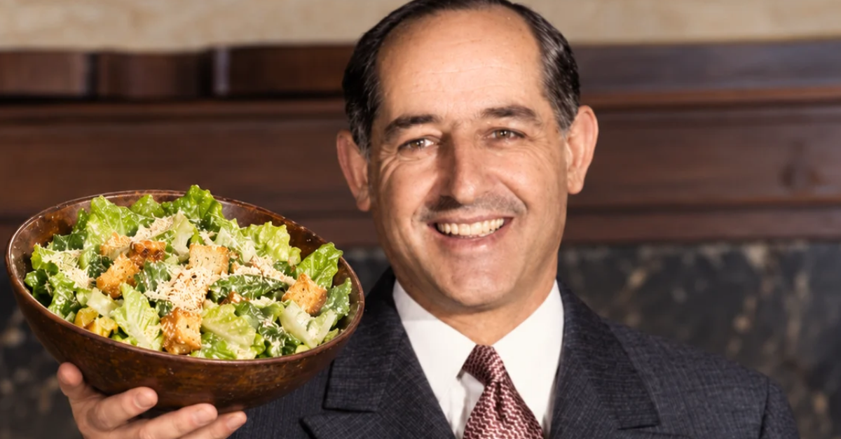 Caesar Cardini holding a caesar salad.