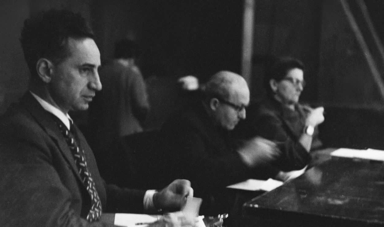 Turkish-born American film director, screenwriter and actor Elia Kazan (1909-2003), Polish-born American actor, director, and drama teacher Lee Strasberg (1901-1982), and American theatre director Cheryl Crawford (1902-1986), sitting behind a desk, at the Actors Studio in the Manhattan borough of New York City, New York, circa 1955.