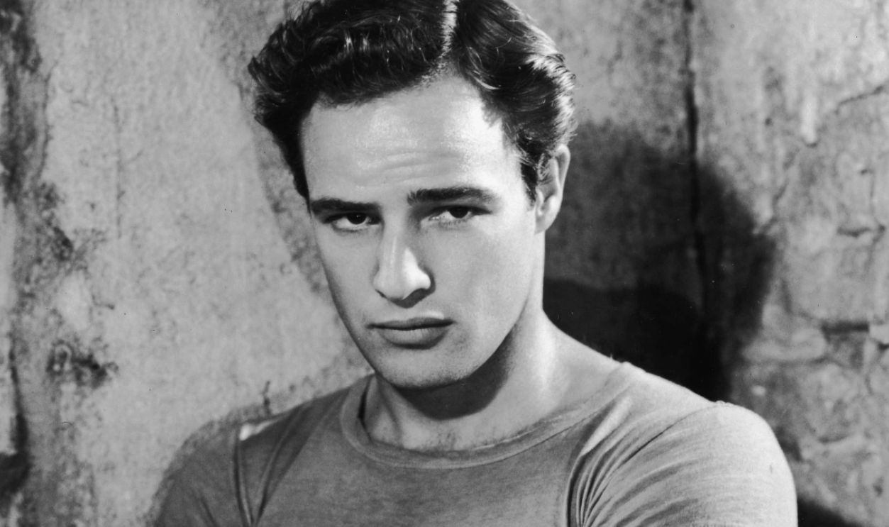 Promotional portrait of American actor Marlon Brando with his arms folded, circa 1951.