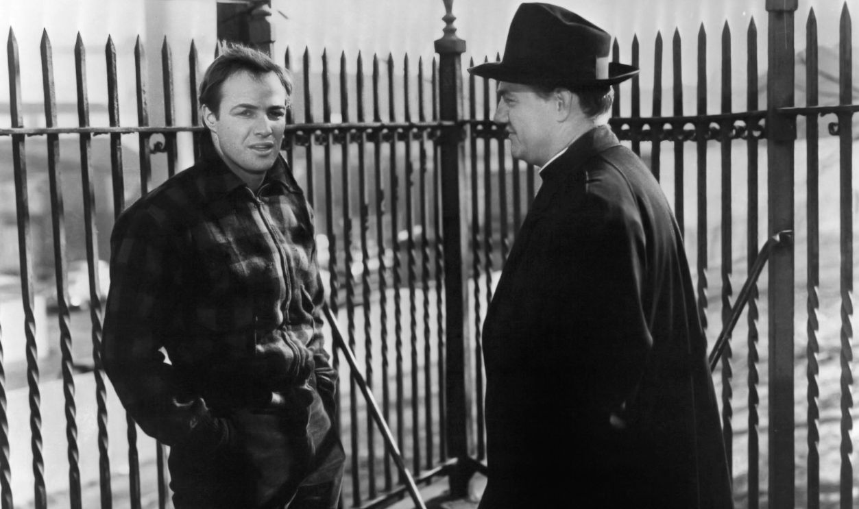 American actors Marlon Brando (1924 - 2004, left), as Terry Malloy, and Karl Malden (1912 - 2009) as Father Barry, in 'On The Waterfront', directed by Elia Kazan, 1954.