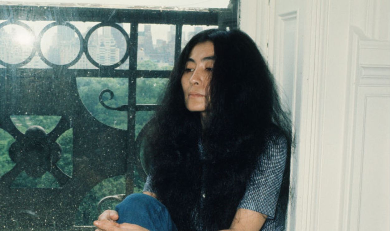 (MANDATORY CREDIT Koh Hasebe/Shinko Music/Getty Images) Yoko Ono sitting in the window of an apartment during an interview in New York, 28th June 1973. 