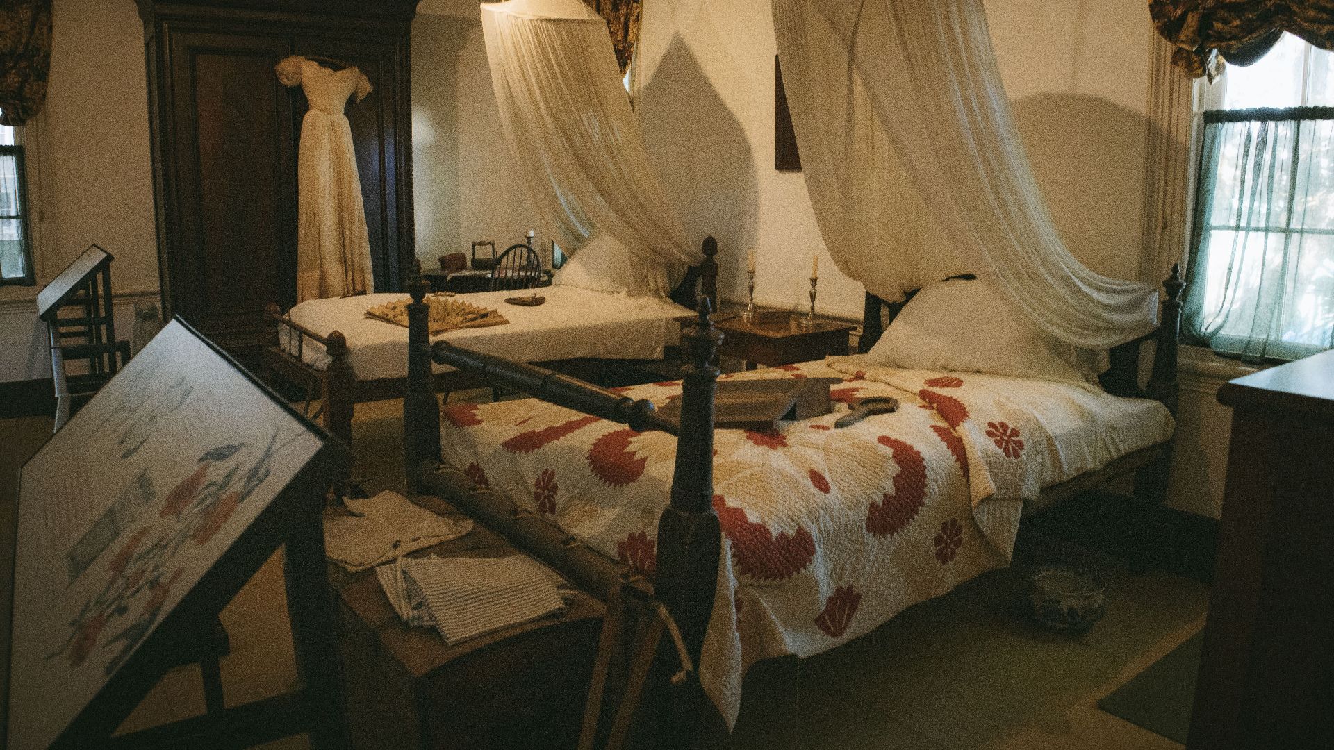 A vintage bedroom exhibit in a Key West museum showcasing period furniture and decor.