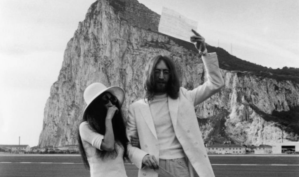 Yoko Ono & Yoko Ono, both dressed in white, pose with their marriage certificate after their wedding in Gibraltar, 20th March 1969.