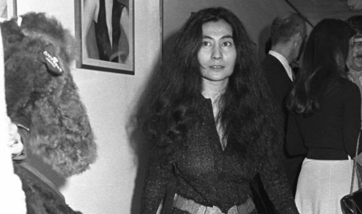 Japanese artist Yoko Ono wearing hot pants and platform go-go boots at an art gallery