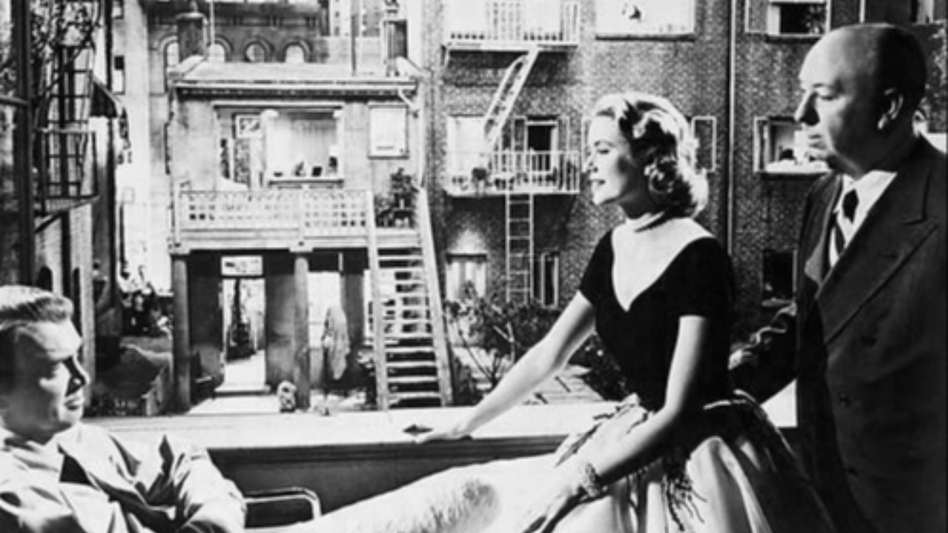 Photo of James Stewart, Grace Kelly & Alfred Hitchcock taken for film Rear Window (1954).