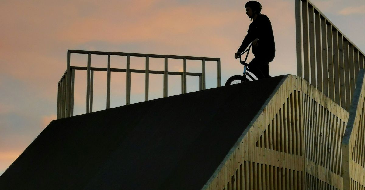 man in black jacket and pants walking on the stairs