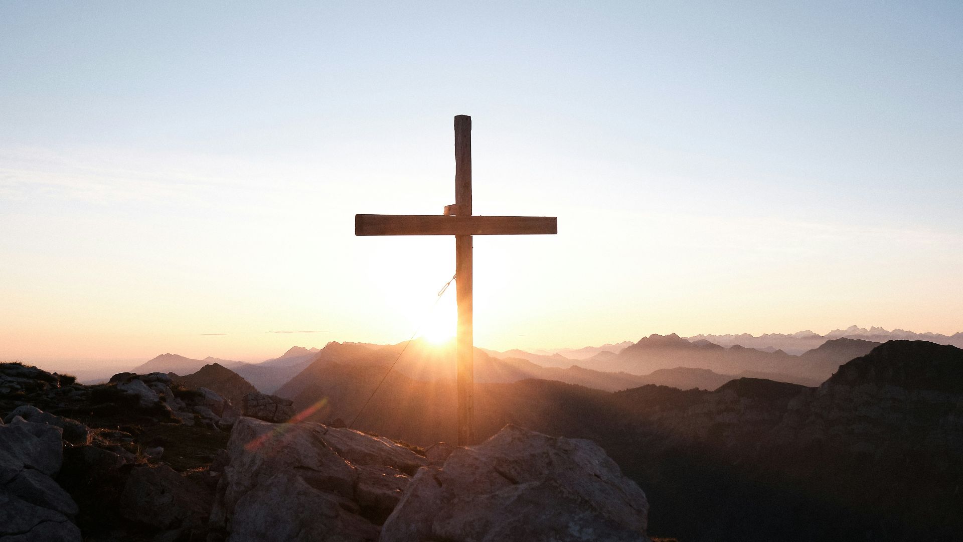 brown cross on brown rock during daytime