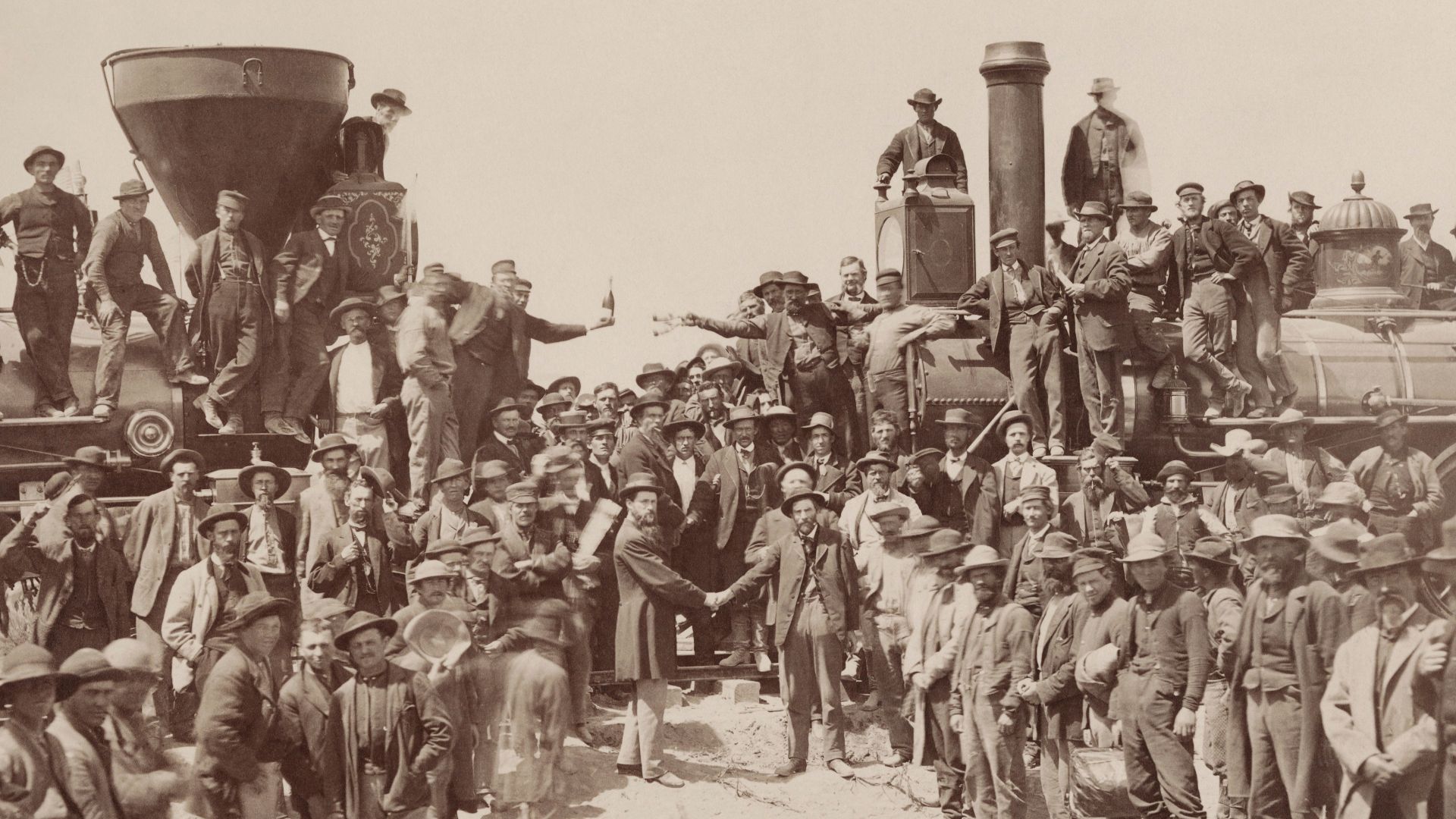 The ceremony for the driving of the golden spike at Promontory Summit, Utah on May 10, 1869; completion of the First Transcontinental Railroad. At center left, Samuel S. Montague, Central Pacific Railroad, shakes hands with Grenville M. Dodge, Union Pacif