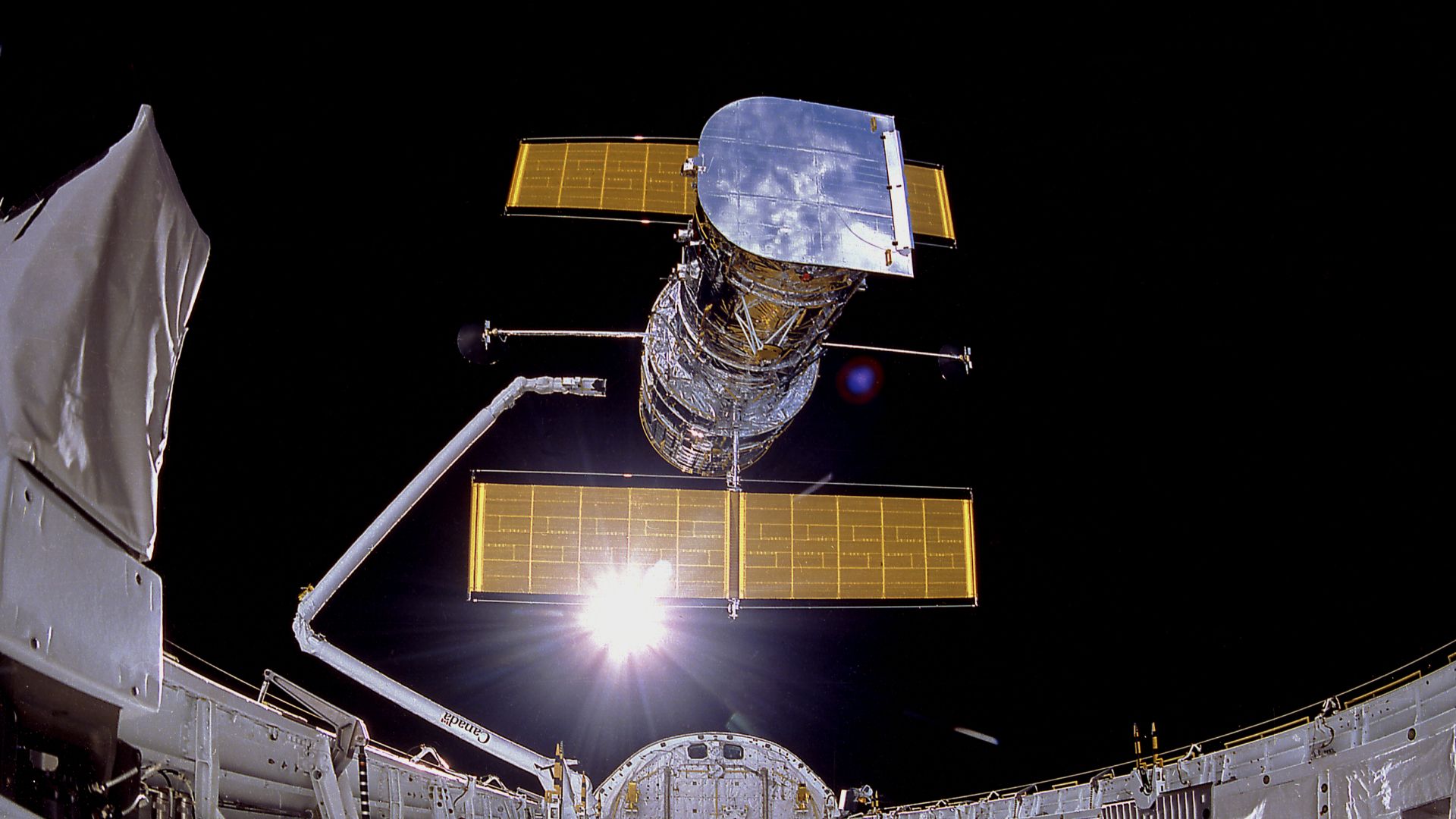 This photograph shows the Hubble Space Telescope being deployed on April 25, 1990. The photograph was taken by the IMAX Cargo Bay Camera (ICBC) mounted in a container on the port side of the Space Shuttle Discovery on the STS-31 mission.