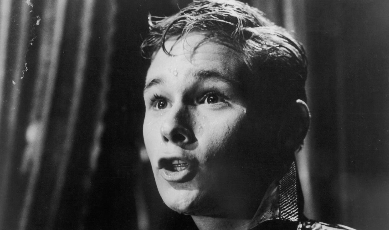 Brandon deWilde stands in the rain in a scene from the film 'All Fall Down', 1962.