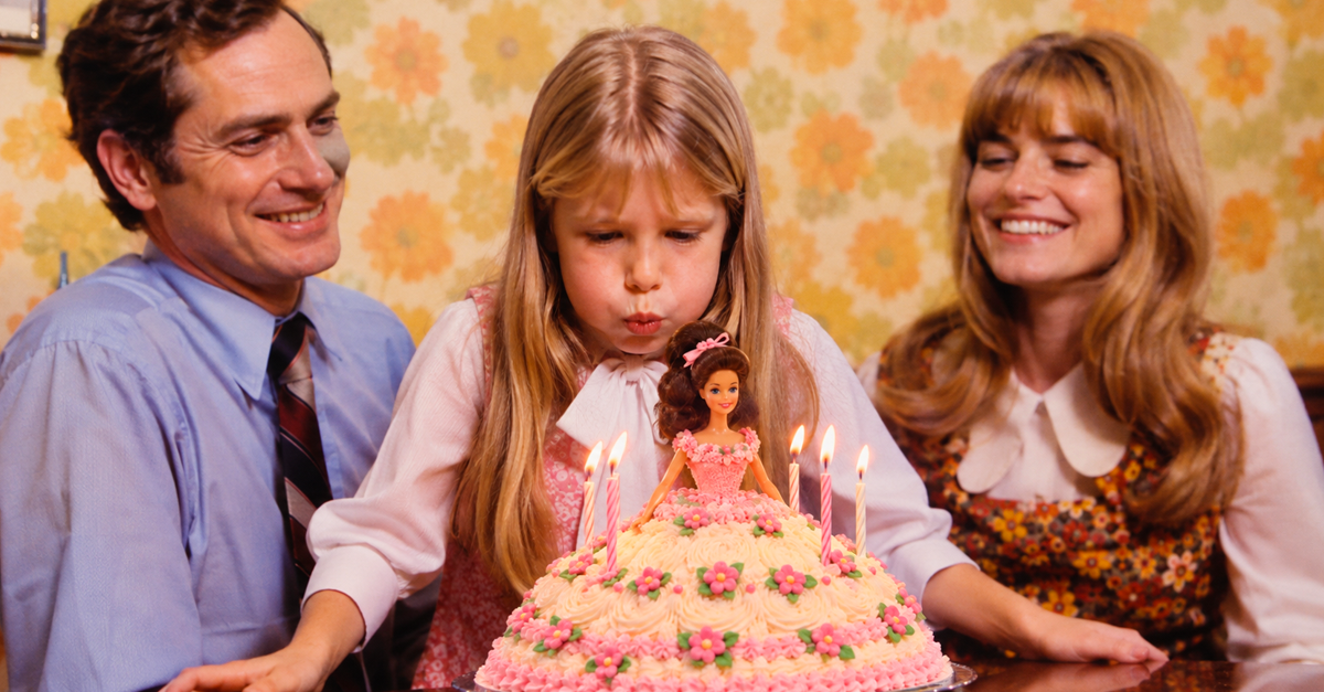 AI-generated image of a girl blowing out candles on a Barbie cake