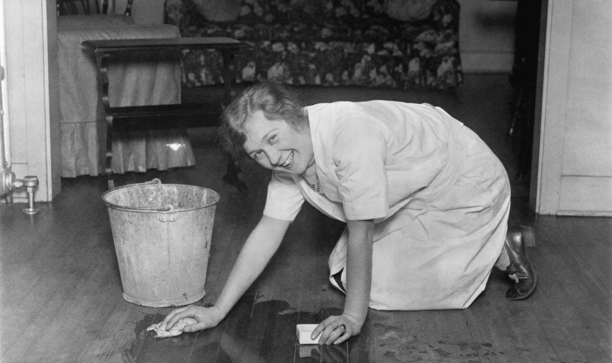 Smiling Housewife Scrubbing Floor
