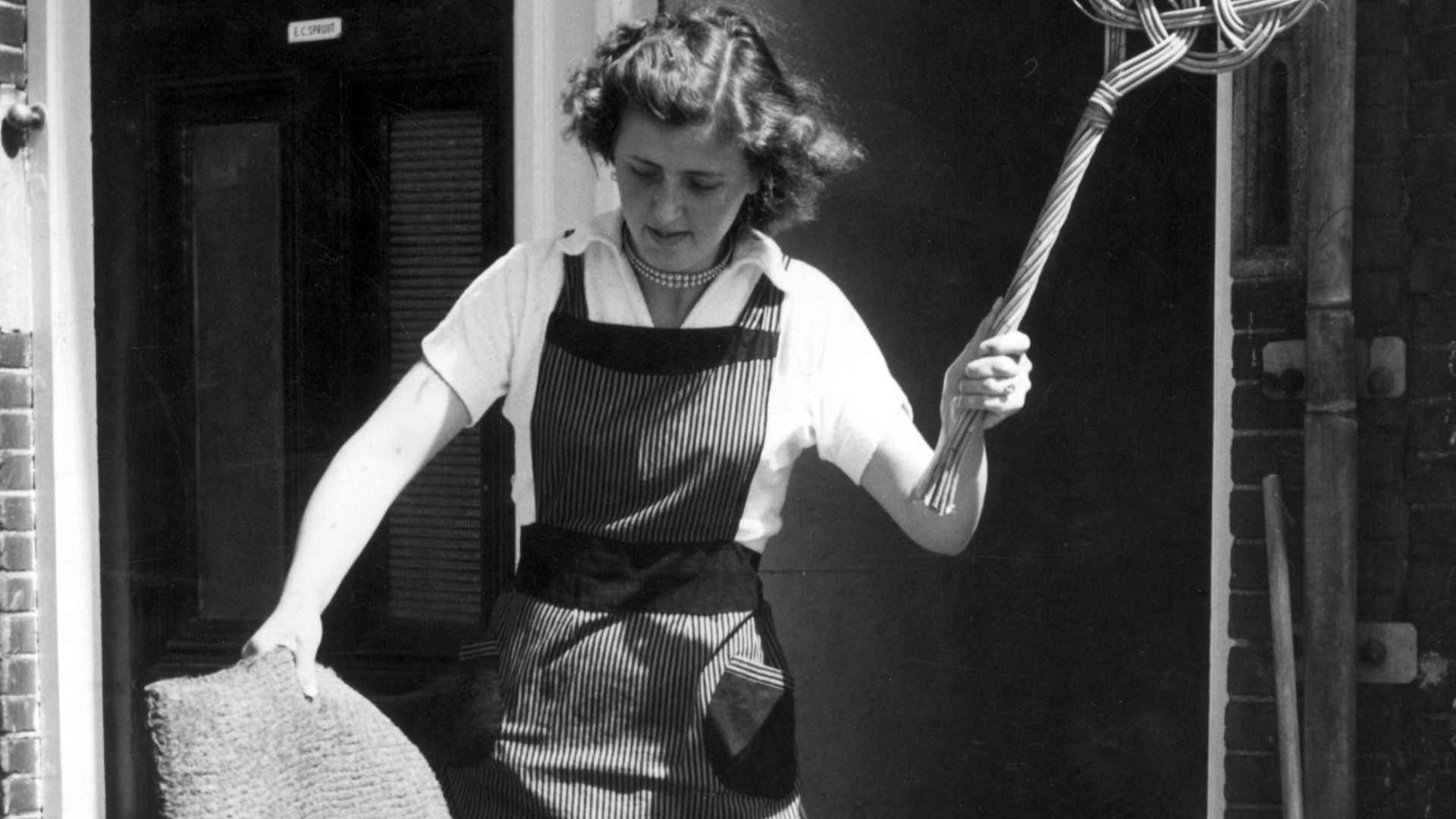 Spaarnestad Photo, SFA001015318 Housewife cleaning doormat with carpet-beater. The Netherlands, [1955].
