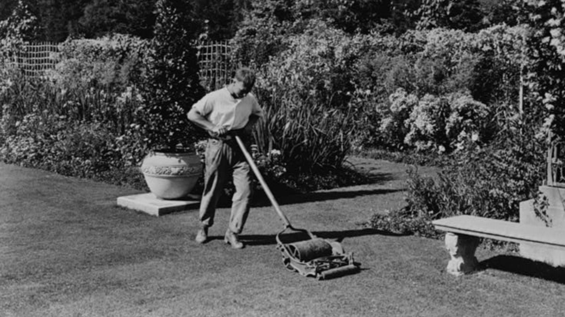 Title: Gardener pushing lawn mower, posed to illustrate Rudyard Kipling's poem The Glory of the Garden
Abstract/medium: 1 photographic print ; 8 x 10 inches.