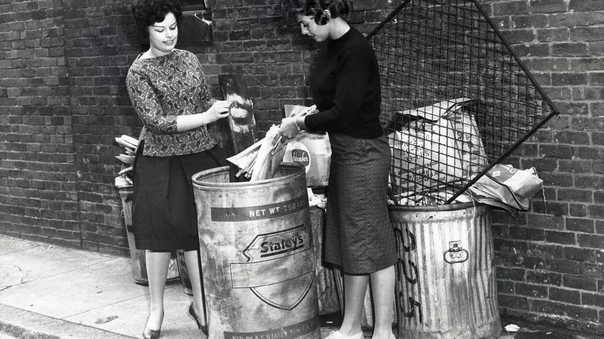 Title: Two unidentified women discarding items in trash can
Creator: City of Boston
Date: circa 1960-1968
Source: Mayor John F. Collins records, Collection #0244.001
File name: 244001_0287
Rights: Copyright City of Boston

Citation: Mayor John F. Collins 